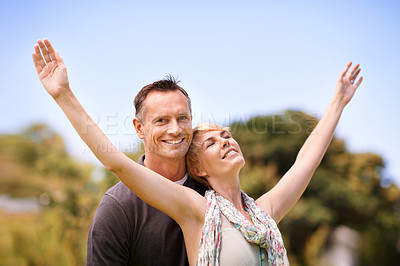 Buy stock photo Couple, portrait and smile with love outdoors for honeymoon vacation, together and arms up for freedom. Man, woman and relationship with care for romance, marriage and support with happiness