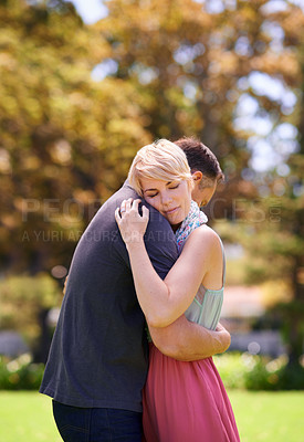 Buy stock photo Shot of a mature couple embracing in the park