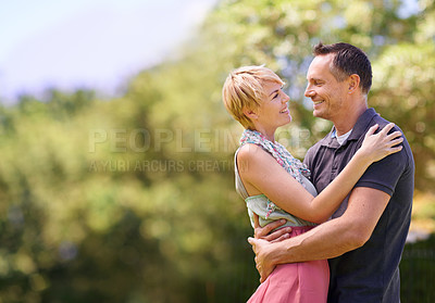 Buy stock photo Love, smile and happy couple hug in park with trust, support or solidarity, security or bonding in nature. Commitment, eye contact or people embrace in forest for spring romance, fun or outdoor date