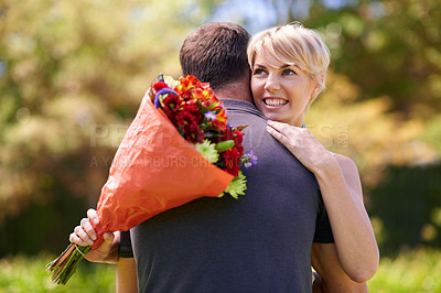 Buy stock photo Hug, happy couple and gift of flowers outdoor in nature, bonding and date on valentines day. Bouquet, man and woman embrace with present for love, care and romantic connection at garden together