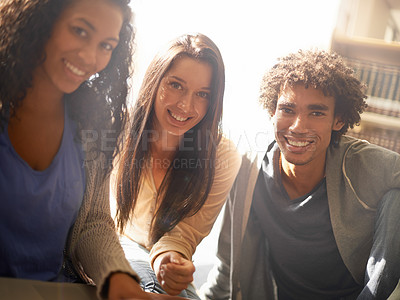 Buy stock photo A group of college students sitting together for a study session