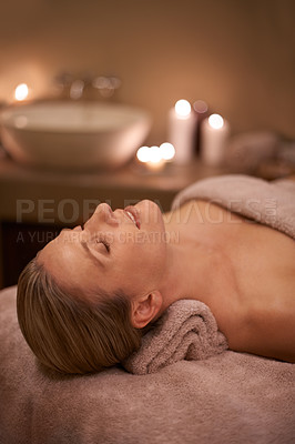 Buy stock photo Blonde woman, massage therapy and candlelight for wellness, smile and relaxation to destress and pamper. Female person, self care and cleanse for detox, spa day and peace for beauty and happiness