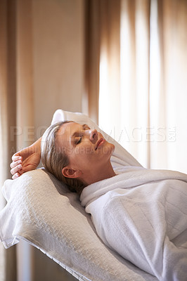 Buy stock photo Woman, massage bed and calm in spa for peace of mind, wellness and luxury for self care and body detox. Female person, relax and smile for stress relief with eyes closed, treatment and break for zen