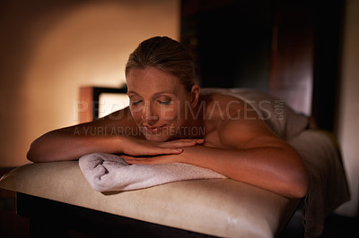 Buy stock photo Woman, smile and relax for wellness, spa and healthy weekend getaway at luxury retreat in Amsterdam. Female person, rest and eyes closed with lying, massage table and peace for holistic self care