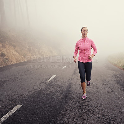 Buy stock photo Nature, fitness and woman athlete running on mountain road for race, marathon or competition training. Sports, exercise and female person with cardio workout in misty outdoor woods or forest.