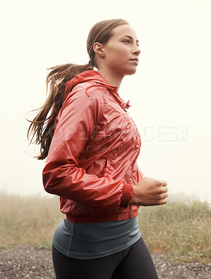 Buy stock photo Nature, sports and woman athlete running on mountain road for race, marathon or competition training. Fitness, exercise and female person with cardio workout in misty outdoor woods or forest.