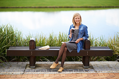 Buy stock photo Coffee, park and portrait of woman on bench with newspaper for lunch break, relax and calm in nature. Happy, reading and person outdoors with caffeine drink, beverage and tea by lake on weekend