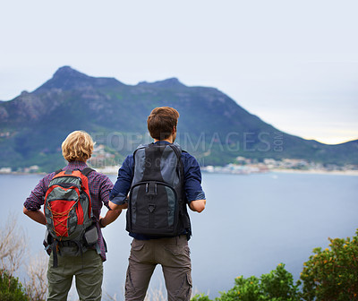 Buy stock photo Friends, hiking and back on mountains for fitness, outdoor and wellness in nature with cityscape in Europe. People with backpack for trekking, journey and adventure or travel by an ocean or island