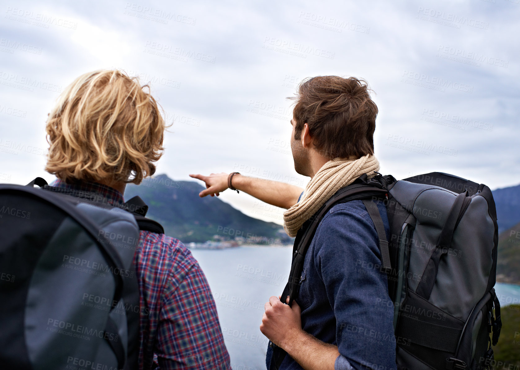 Buy stock photo Man, friends and backpack for hiking by ocean in travel, sightseeing or outdoor journey in nature. Rear view of male person or hikers with bag on back for trekking, fitness or adventure by cloudy sky
