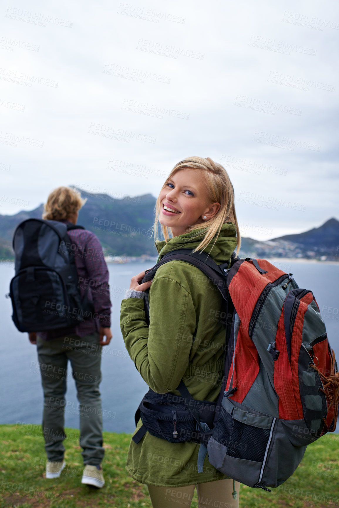 Buy stock photo Happy couple, portrait and hiking with backpack for adventure, travel or outdoor journey together in nature. Young man and woman with smile and bag for trekking, explore or fitness by the ocean coast