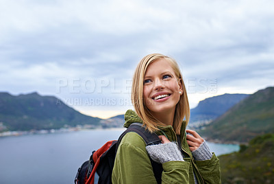 Buy stock photo A young woman looking over her shoulder and enjoying the beauty of nature