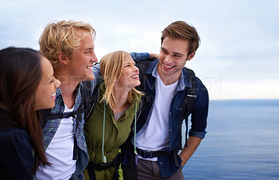 Buy stock photo Friends, group and happy on by ocean for hiking, adventure and talking of eco friendly tourism, travel and sightseeing. Young people with backpack and excited to explore, trekking or outdoor journey 