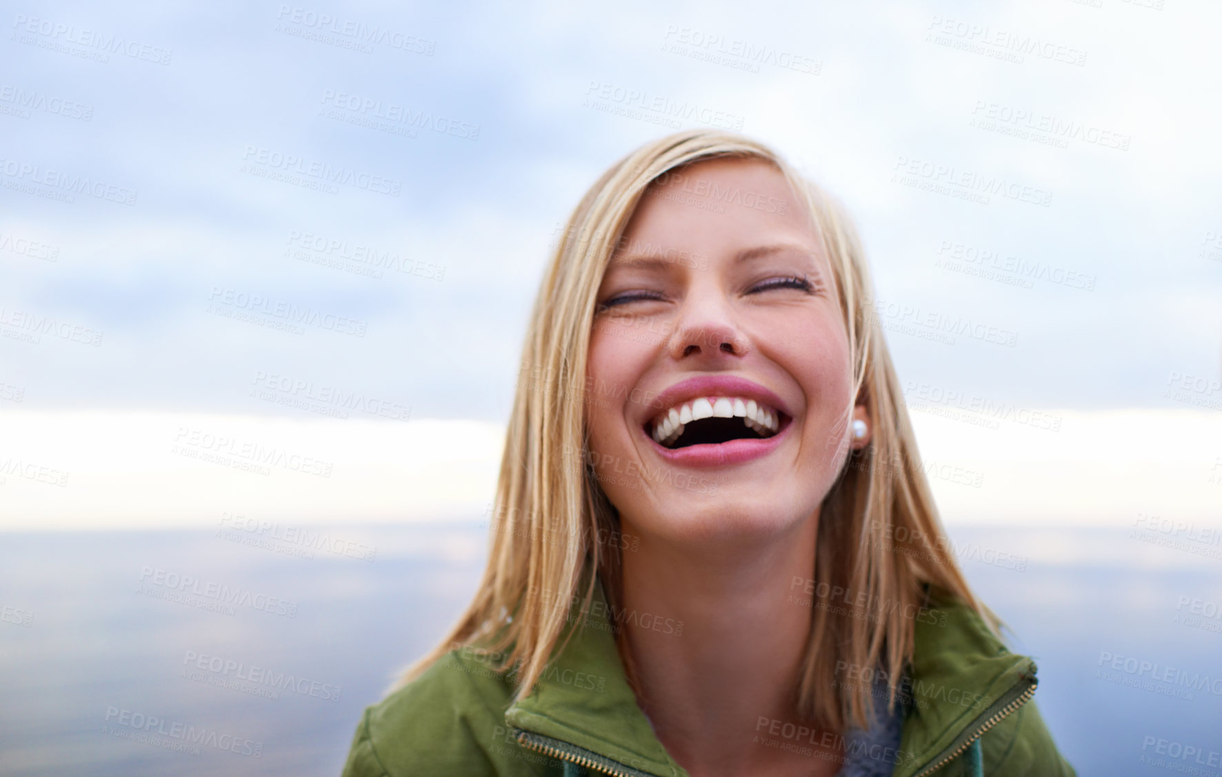 Buy stock photo Woman, excited and happy at the beach for holiday, vacation and travel in winter. Face of a young person in the USA laughing and smile by an ocean, sea or lake with cloudy sky for outdoor adventure