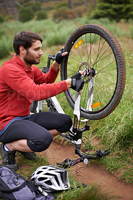Buy stock photo Exercise, bicycle and fixing wheel with man cyclist in countryside for sports, hobby or cardio training. Fitness, cycling or tyre puncture with young athlete and bike outdoor in nature for workout