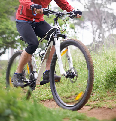 Buy stock photo A cropped shot of a cyclist riding a trail