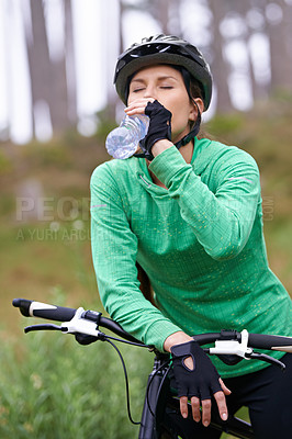 Buy stock photo Woman, drinking water and nature with bicycle for cycling, fitness or break on off road trail or path. Thirsty female person, athlete or cyclist with beverage in forest or rest for outdoor workout