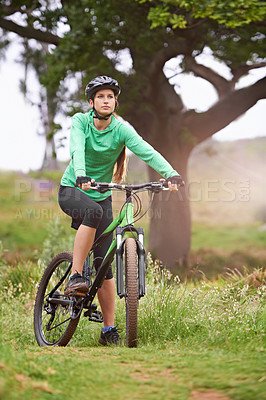 Buy stock photo Woman, sports and fitness with bicycle on field for outdoor cycling, workout or cardio exercise in nature. Female person, athlete or cyclist in forest for off road training on green grass or trail