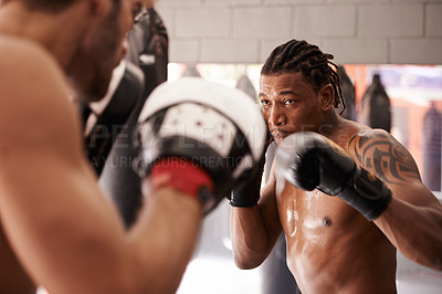 Buy stock photo Men, coach and martial arts with combat training in fight, gloves and partner for punch at gym. People, challenge and action for mma, boxing and hands with power, workout and exercise for competition