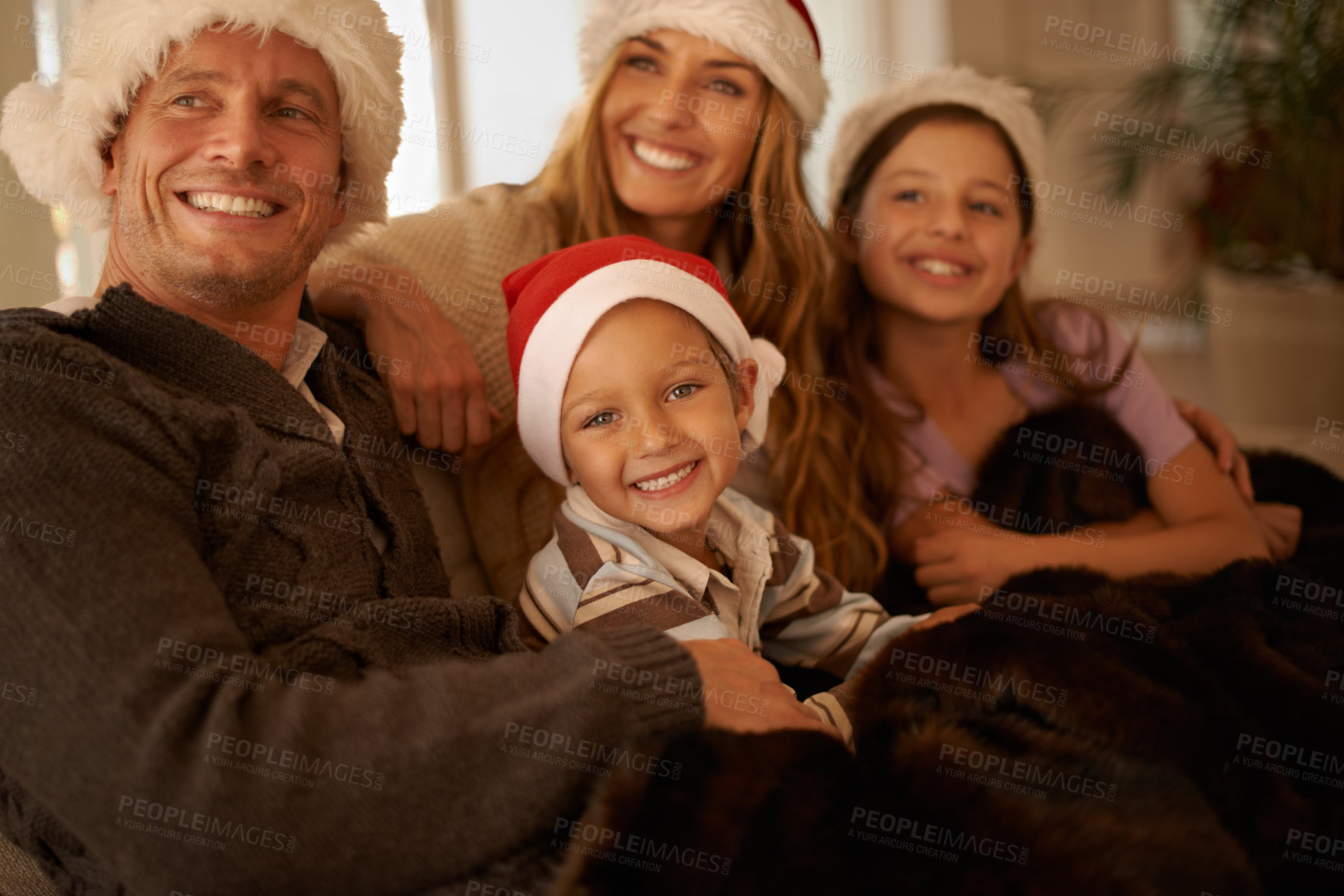 Buy stock photo Mother, father and children on Christmas as a happy family to celebrate a Christian holiday together at home. Celebration, mom and dad enjoy quality time with kids or siblings on sofa in living room