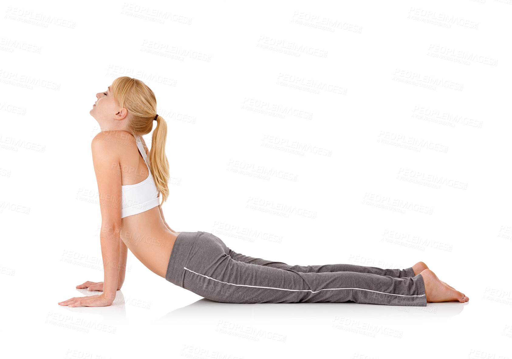 Buy stock photo Woman, yoga and stretching on floor in studio for exercise, healthy body and wellness with fitness and mockup space. Pilates, person and warm up with sportswear for flexibility on white background