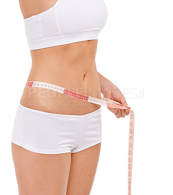Buy stock photo Woman, stomach and measure in studio for weight loss, tape and fitness for health. Female person, results on progress and nutrition for slim body, abdomen and workout isolated with white background