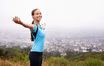 Buy stock photo Shot of a young woman training outdoors with her arms outstretched