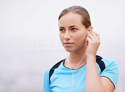 Buy stock photo Face, fitness and music with runner woman outdoor on misty morning for health or cardio workout. Exercise, running or training and confident young athlete listening to audio sound on earphones