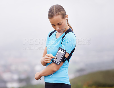 Buy stock photo Fitness, phone and music with runner woman outdoor in mountains for health or cardio workout. Exercise, running and training with young athlete in nature or countryside for physical improvement