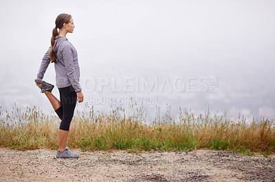 Buy stock photo Fitness, space and stretching with runner woman outdoor on mountain trail for cardio workout. Exercise, nature and view with confident young athlete on foggy morning for running or marathon training