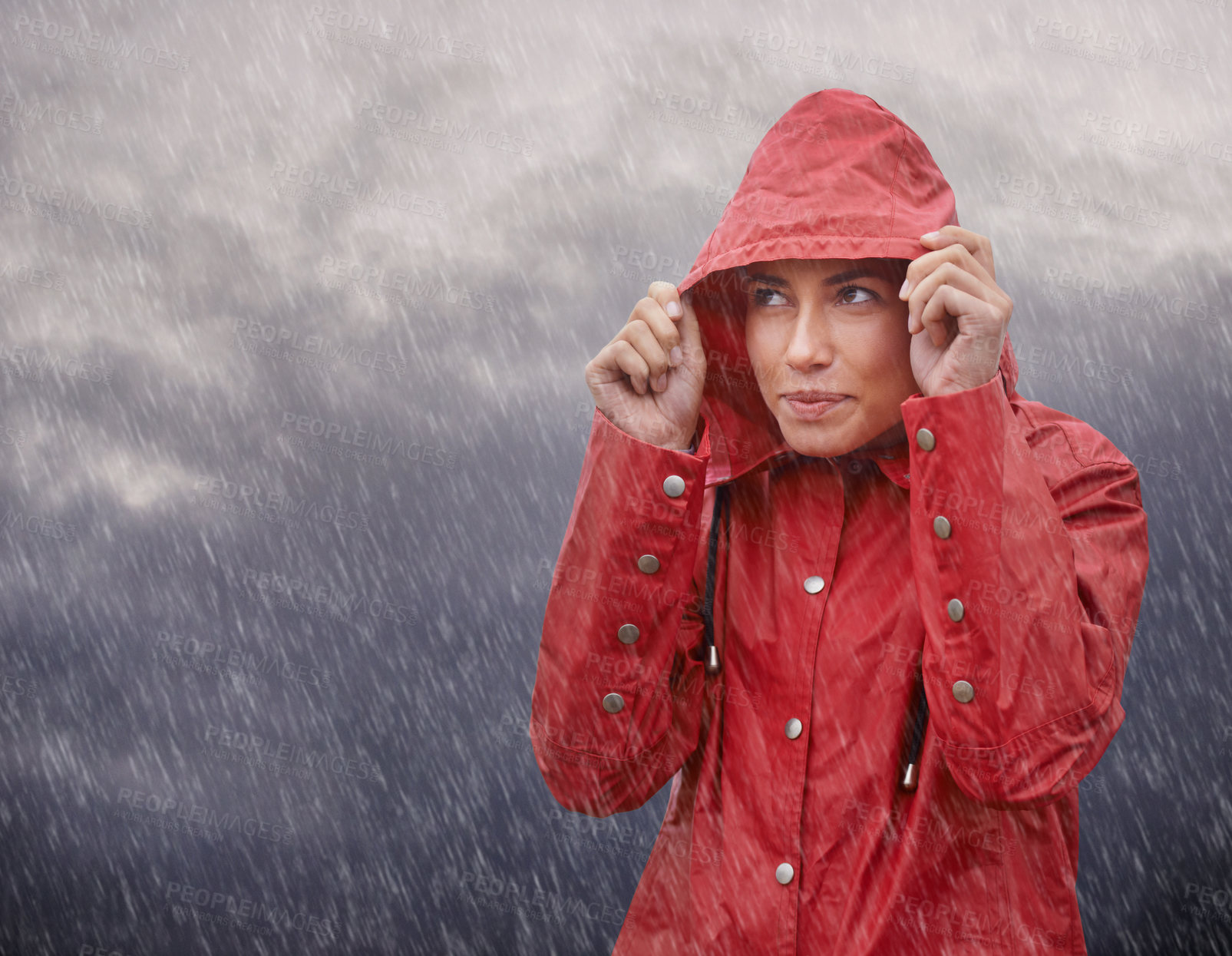 Buy stock photo Cropped shot of an attractive young woman standing in the rain