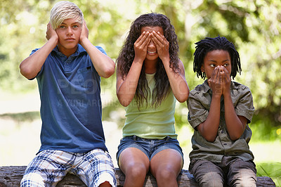 Buy stock photo Kids, see and hear or speak no evil, forest bench and sitting down for playing, face, covering ears or mouth. Children, nature and gesture for innocence, development and learning together in nature