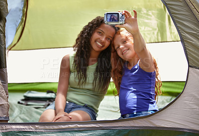 Buy stock photo Happy girl, friends and selfie in tent for memory, camping or photography together with camera. Young female person, child or kids with smile for picture, photo or social media in relax or friendship