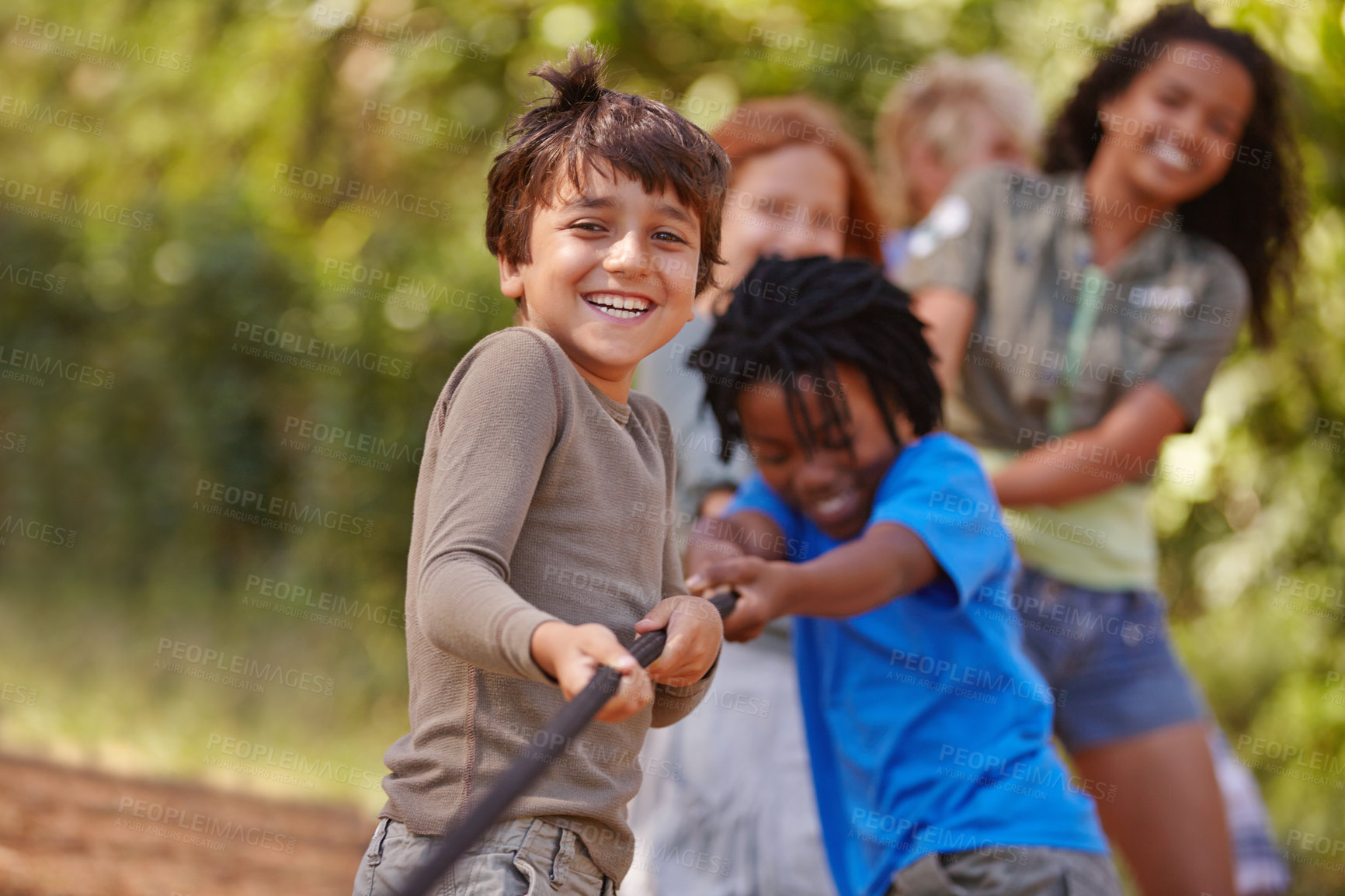 Buy stock photo A group of kids in a tug-of-war game