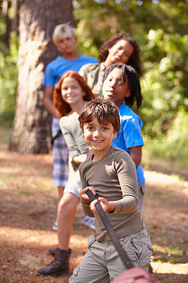 Buy stock photo A group of kids in a tug-of-war game