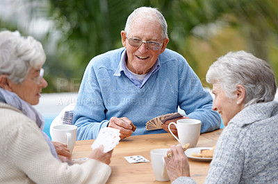 Buy stock photo A group of senior citizens playing cards together