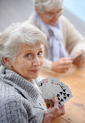 Buy stock photo Shot of senior citizens playing cards together