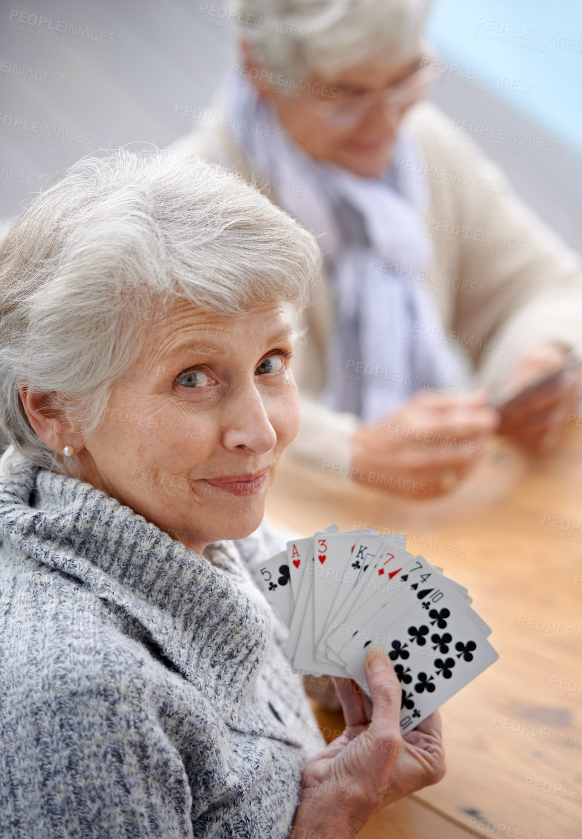 Buy stock photo Shot of senior citizens playing cards together