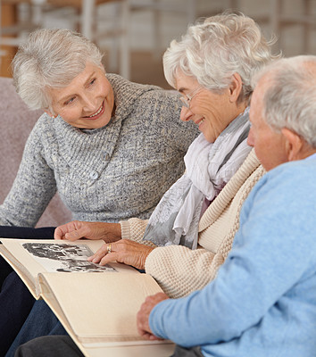 Buy stock photo Shot of seniors looking through a photo album