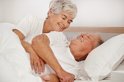 Buy stock photo Senior couple, hug and communication in bed, relaxing and love in retirement for bonding on weekend. Happy elderly people, conversation and embracing in marriage, romance and morning routine at home
