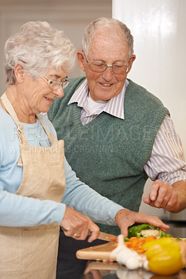 Buy stock photo Cropped shot of an elderly couple preparing a meal together
