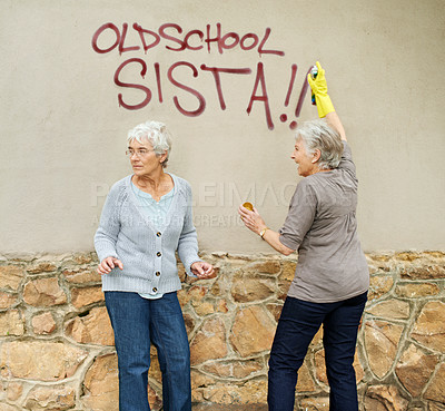 Buy stock photo Senior women, graffiti or spray painting a wall, looking or vandalism for fun, trouble or humor. Elderly people, together or outdoor by damage to property, friends or retired with can, art or glove