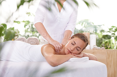 Buy stock photo An attractive young woman having a massage at the spa