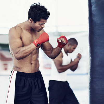 Buy stock photo Man, training and gloves in gym for boxing match, practice and determined for competition to win. Light weight champion, workout and focus for tough sport, fitness and exercise with endurance for mma