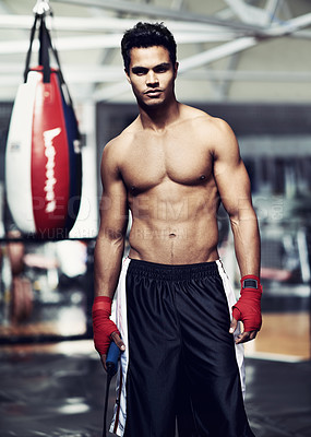 Buy stock photo Portrait of a handsome young boxer standing in the gym