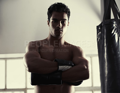 Buy stock photo Man, portrait and confident with boxing gloves in gym for combat sport, fitness and competition for strong people. Male fighter, determined and ready for self defense, focus and fit with muscles