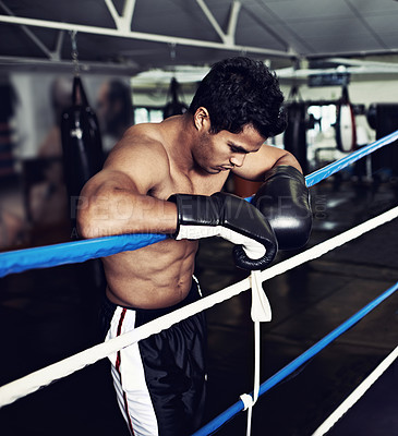 Buy stock photo Sports, break and man boxer in gym for exercise, workout and combat training for competition. Breathing, health and shirtless male athlete fighter in boxing ring with gloves in fitness center.