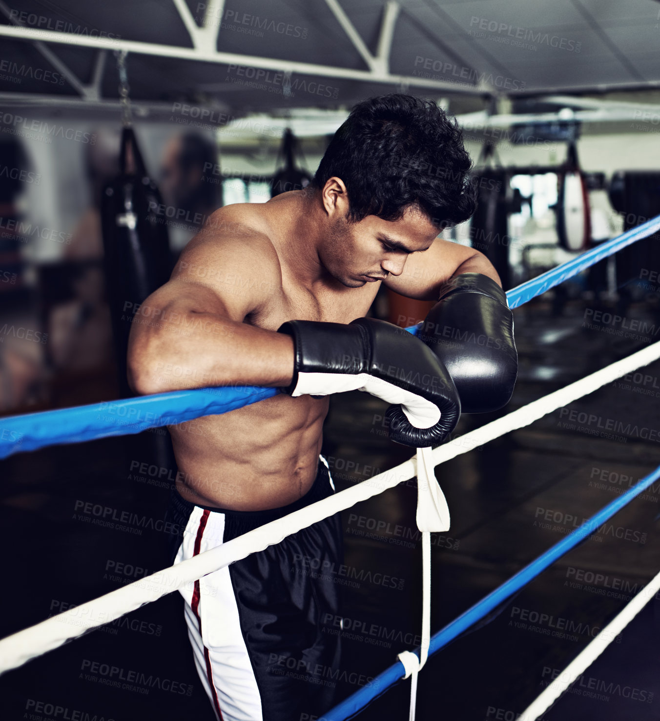 Buy stock photo Sports, break and man boxer in gym for exercise, workout and combat training for competition. Breathing, health and shirtless male athlete fighter in boxing ring with gloves in fitness center.