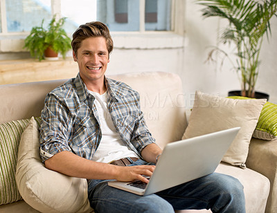 Buy stock photo Laptop, relax and portrait of man on sofa in home for watching videos, networking and browse website. Happy, smile and person with computer for internet, remote work and streaming in living room