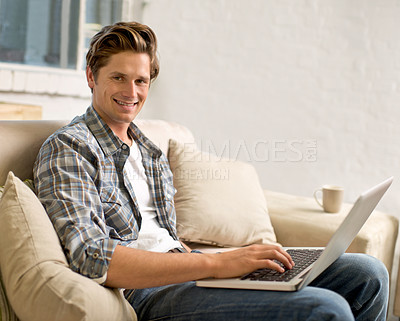 Buy stock photo Laptop, relax and portrait of man on sofa in home for watching videos, online networking and website. Happy, smile and person on computer for internet, remote work and typing email in living room