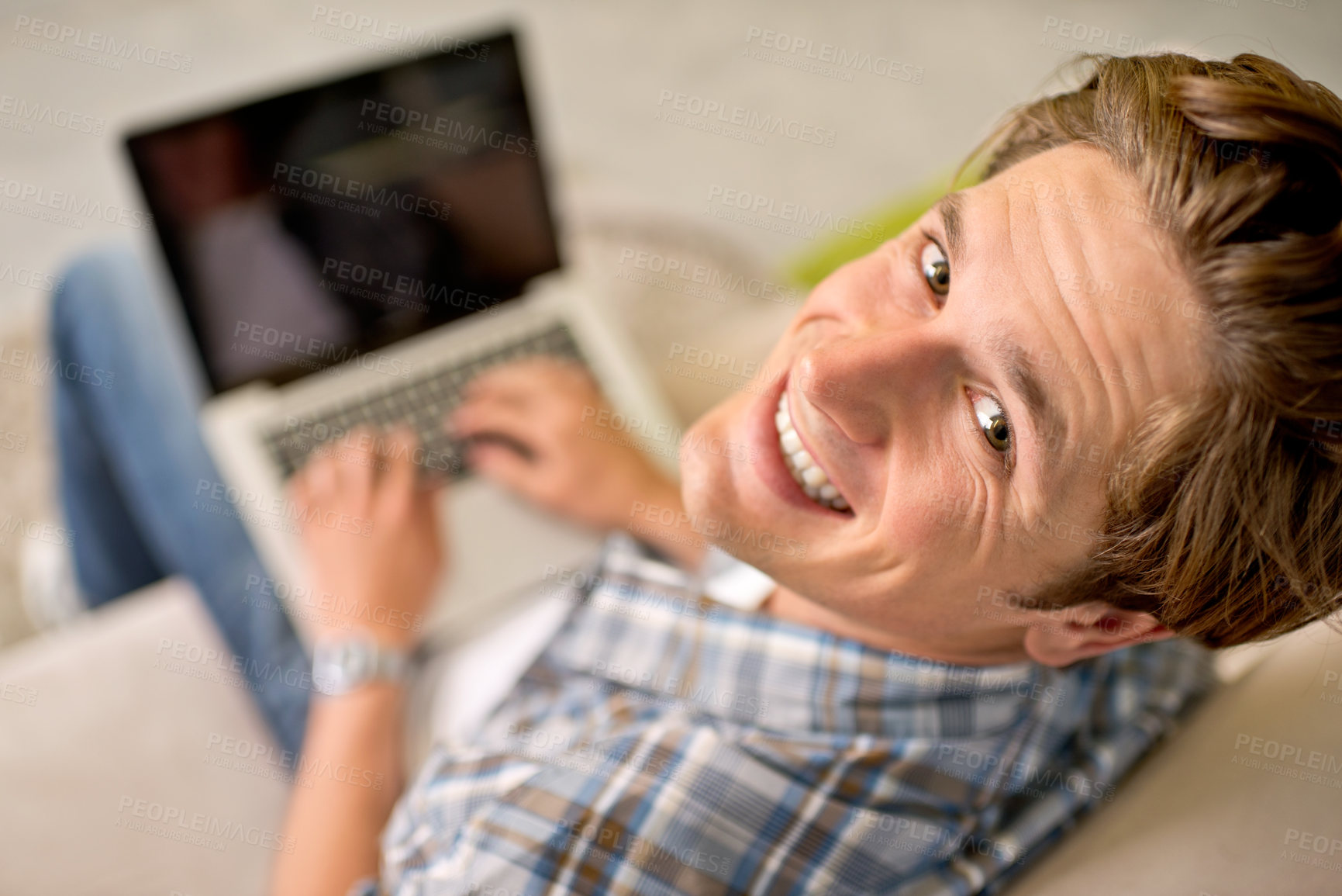 Buy stock photo Man, portrait and laptop on sofa for online as freelance journalist for report research, connectivity or networking. Male person, above and internet for remote work in London, communication or web